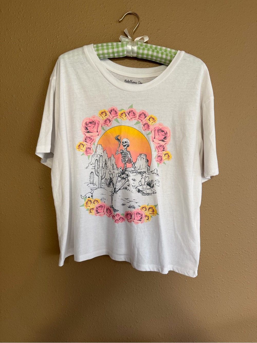 Rebellious One White Tee with Sunset Skeleton and Pink/Yellow Rose Graphic
